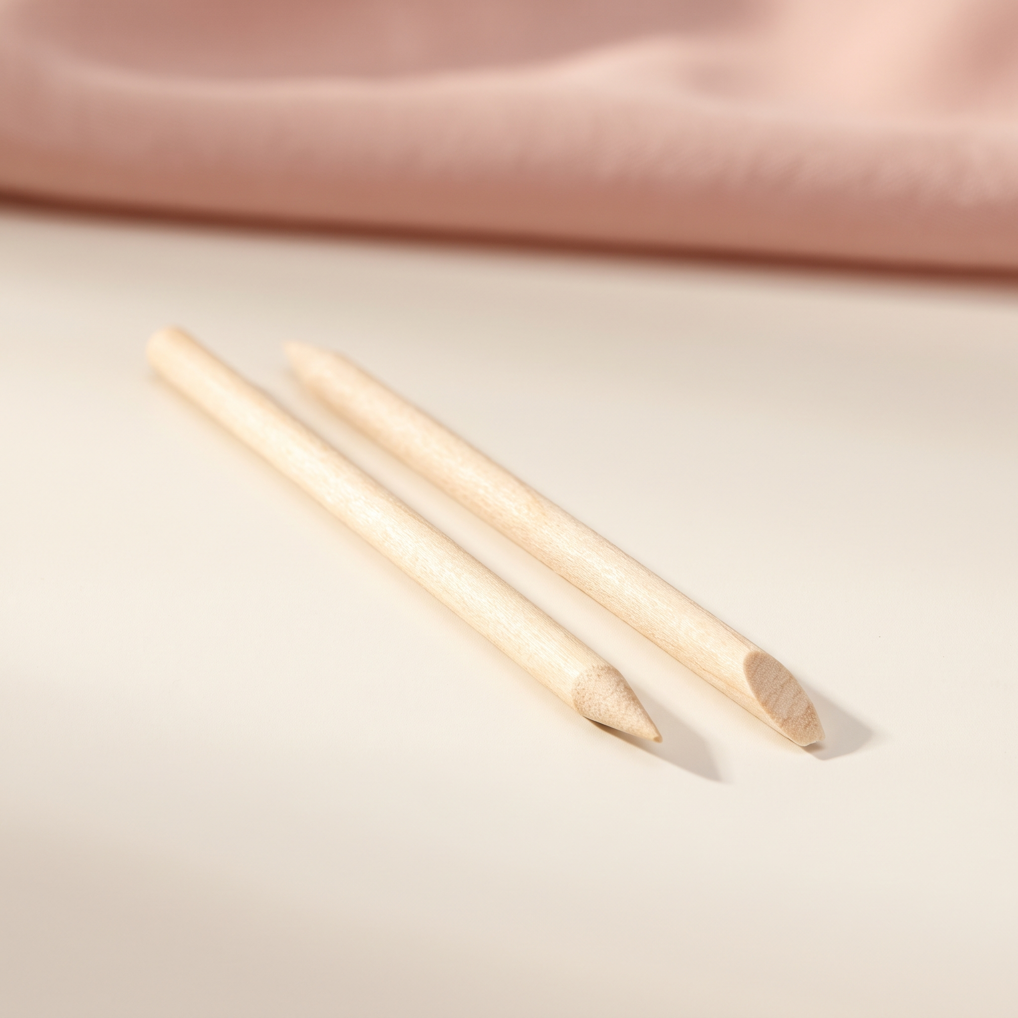Penvy Cuticle Sticks — two natural birchwood sticks on cream